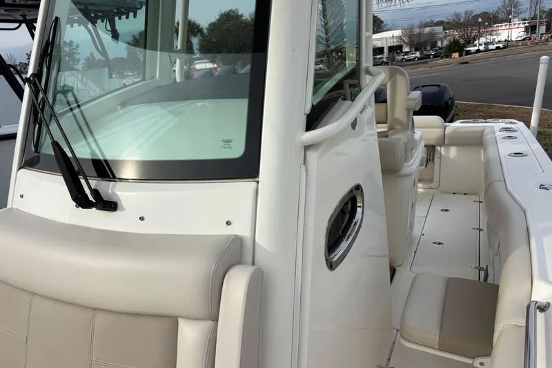 Slide: The Image of 2018 Boston Whaler 250 Outrage boat interior with seating and windshield view. - 15