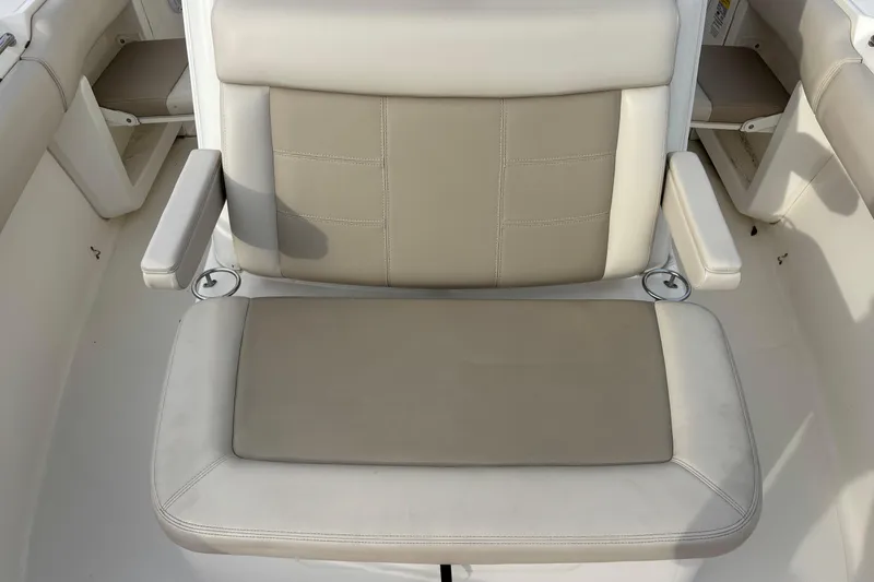 Slide: The Image of 2018 Boston Whaler 250 Outrage boat seat with beige and white upholstery. - 16