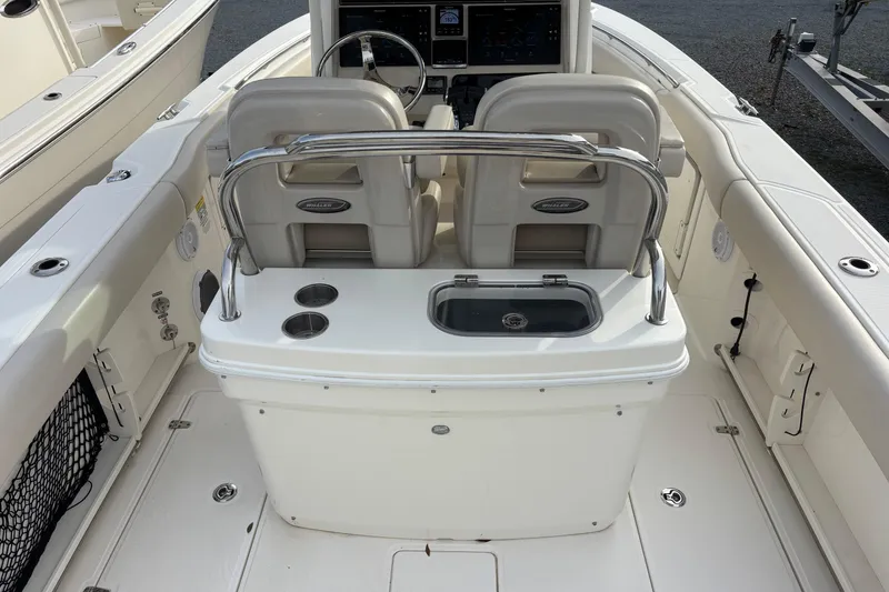 Slide: The Image of 2018 Boston Whaler 250 Outrage boat interior with seating and console. - 6