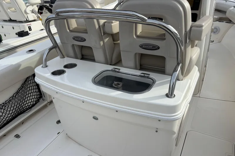 Slide: The Image of 2018 Boston Whaler 250 Outrage boat interior with seating and cup holders. - 7