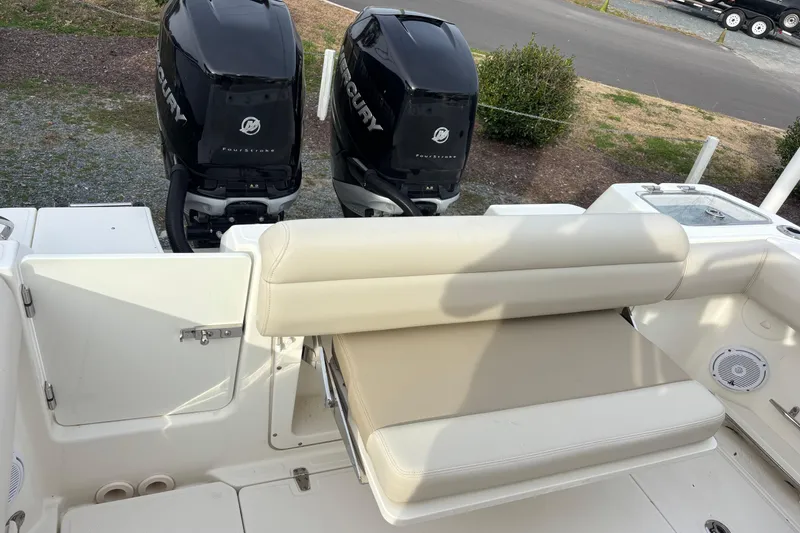 Slide: The Image of 2018 Boston Whaler 250 Outrage boat with twin Mercury engines and cushioned seating. - 9
