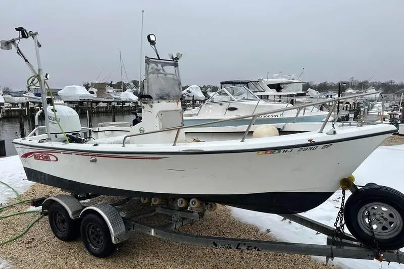 Slide: The Image of 2001 May-Craft 1900CC boat on trailer at marina, winter setting. - 3