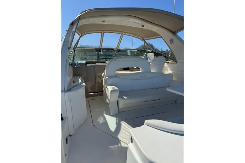 Slide: The Image of 2000 Sea Ray 410 Express Cruiser interior with white seating and helm station. - 10