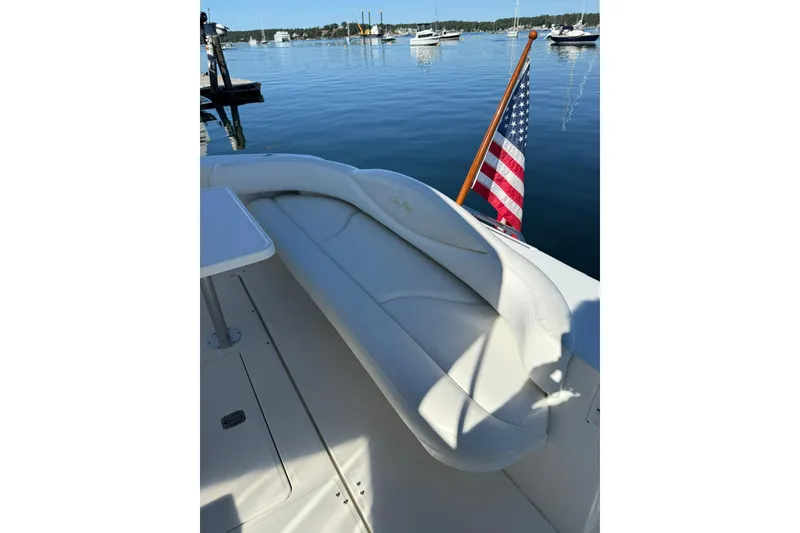 Slide: The Image of 2000 Sea Ray 410 Express Cruiser with American flag, docked in serene waters. - 14