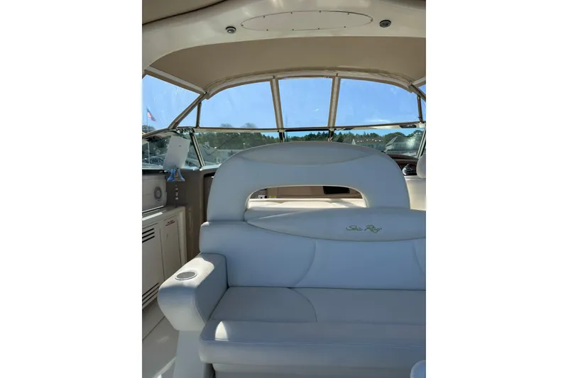 Slide: The Image of Interior view of 2000 Sea Ray 410 Express Cruiser with white seating and helm. - 16