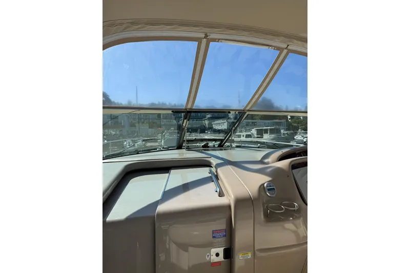 Slide: The Image of 2000 Sea Ray 410 Express Cruiser helm with marina view through windshield. - 18