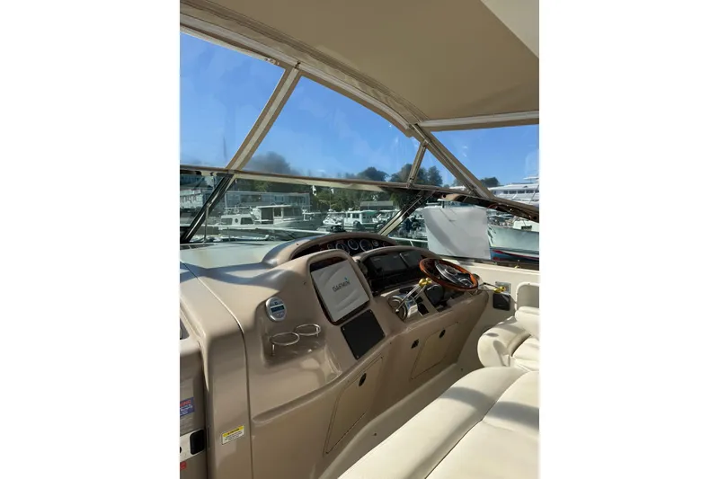 Slide: The Image of 2000 Sea Ray 410 Express Cruiser helm with Garmin navigation, docked at marina. - 19