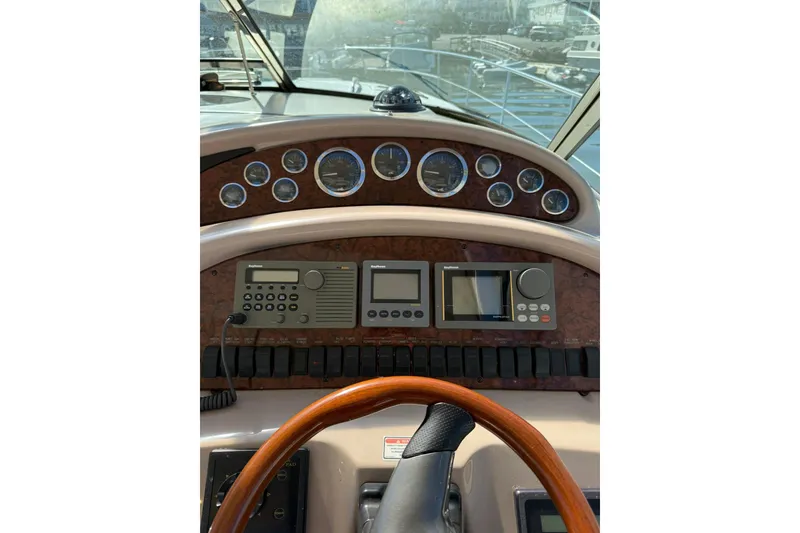 Slide: The Image of Control panel of a 2000 Sea Ray 410 Express Cruiser with navigation instruments. - 26