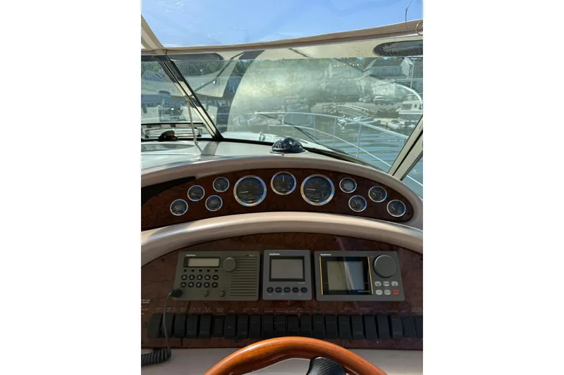 Slide: The Image of Cockpit view of 2000 Sea Ray 410 Express Cruiser with navigation instruments. - 27