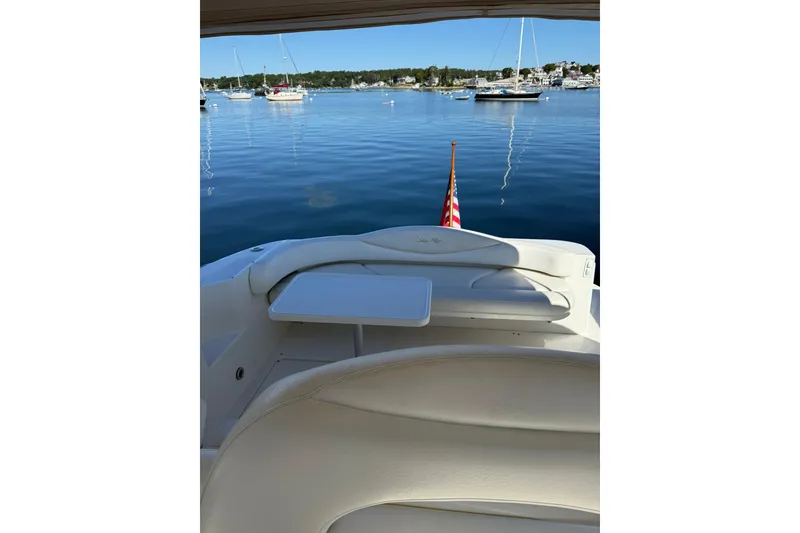 Slide: The Image of 2000 Sea Ray 410 Express Cruiser, rear seating area with scenic harbor view. - 30