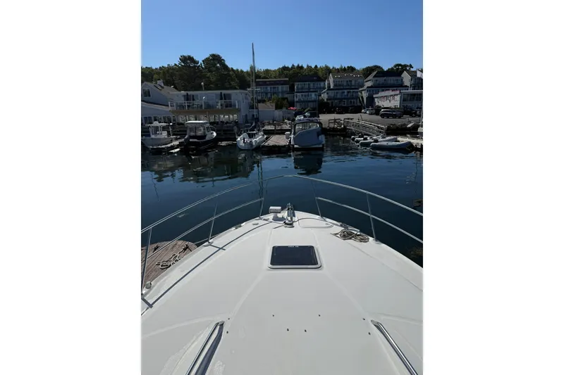 Slide: The Image of Bow view of 2000 Sea Ray 410 Express Cruiser docked in a marina. - 33