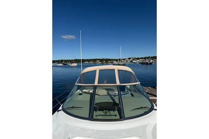 Slide: The Image of 2000 Sea Ray 410 Express Cruiser docked in a serene marina under clear blue skies. - 38