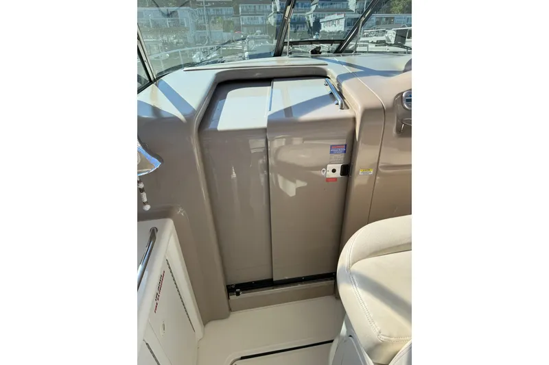 Slide: The Image of 2000 Sea Ray 410 Express Cruiser helm area with beige seating and control panel. - 40