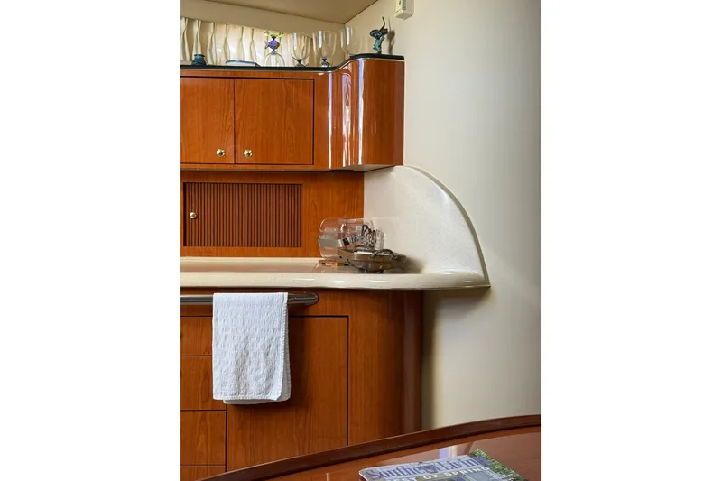 Slide: The Image of Interior of 2000 Sea Ray 410 Express Cruiser with wooden cabinetry and countertop. - 46