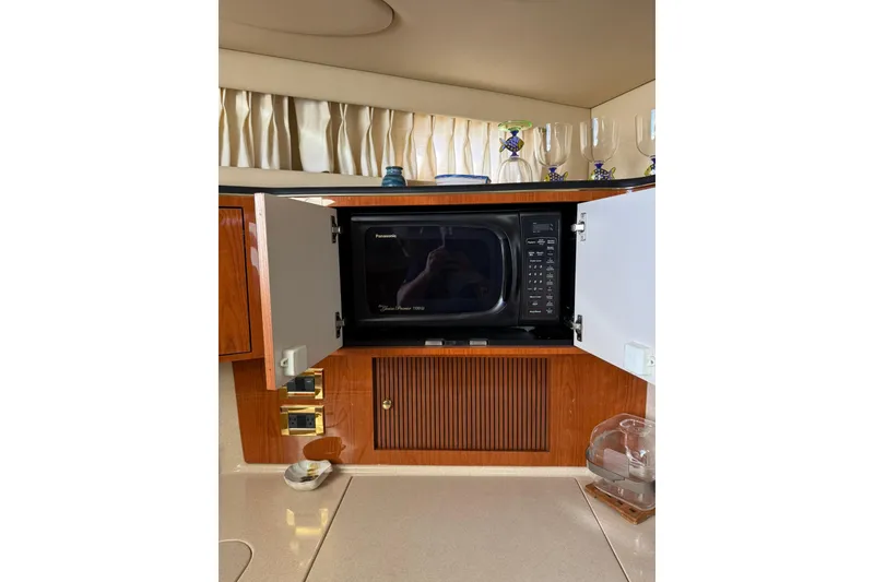 Slide: The Image of Microwave in 2000 Sea Ray 410 Express Cruiser kitchen with wooden cabinetry. - 50