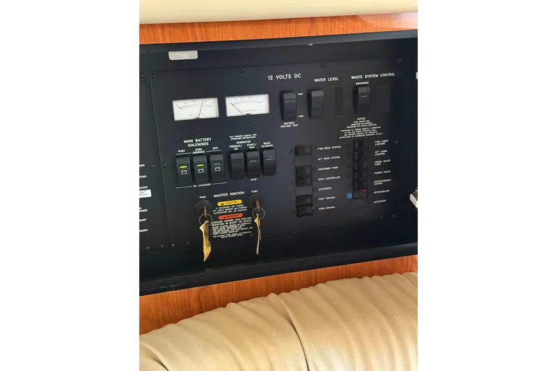 Slide: The Image of Control panel of a 2000 Sea Ray 410 Express Cruiser, featuring switches and gauges. - 52