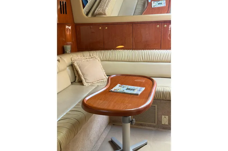 Slide: The Image of Interior of 2000 Sea Ray 410 Express Cruiser with elegant seating and wooden table. - 59