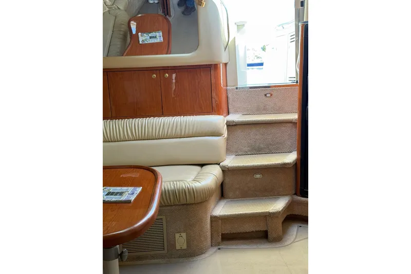 Slide: The Image of Interior of 2000 Sea Ray 410 Express Cruiser with stairs and seating area. - 61