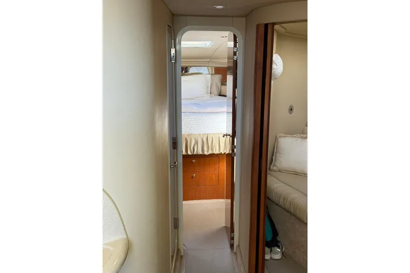 Slide: The Image of Interior view of 2000 Sea Ray 410 Express Cruiser cabin with bed and seating area. - 63