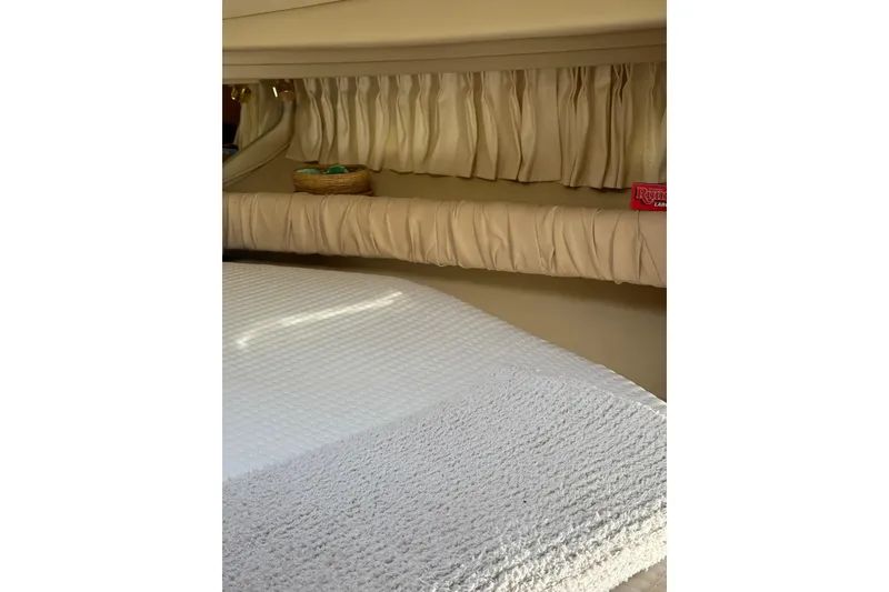 Slide: The Image of Interior cabin of 2000 Sea Ray 410 Express Cruiser with cozy bedding and curtains. - 68