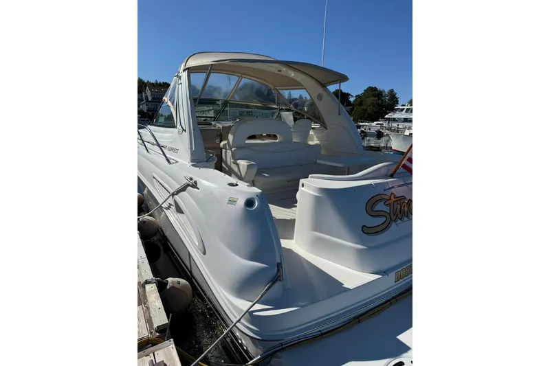 Slide: The Image of 2000 Sea Ray 410 Express Cruiser docked at marina under clear blue sky. - 7