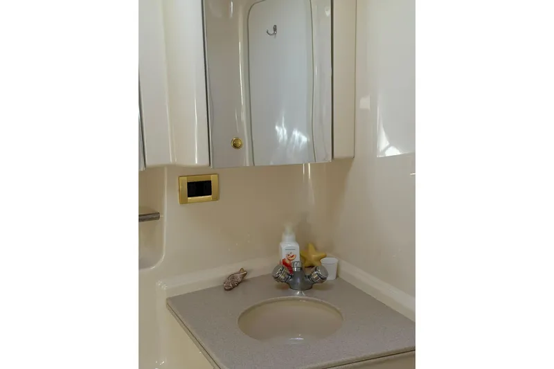 Slide: The Image of Bathroom vanity in 2000 Sea Ray 410 Express Cruiser with mirror and sink. - 72