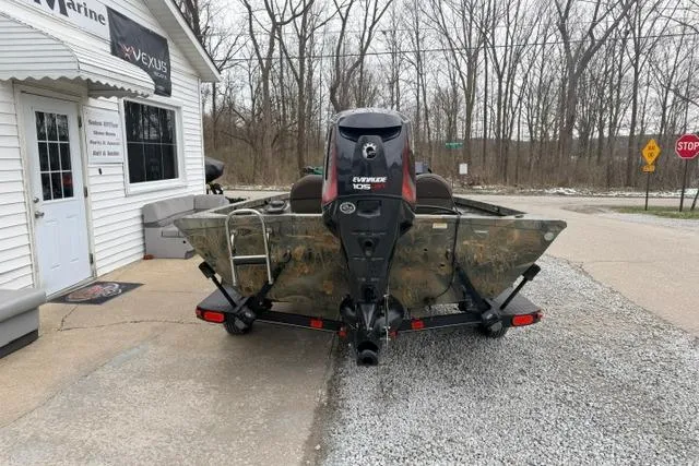 Slide: The Image of 2017 Ranger RT188 boat with Evinrude motor parked outside a marine shop. - 4