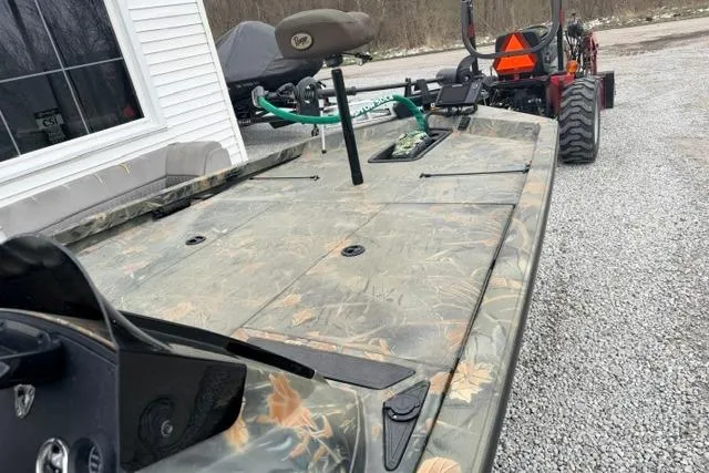 Slide: The Image of 2017 Ranger RT188 boat with camouflage design on a gravel driveway. - 6