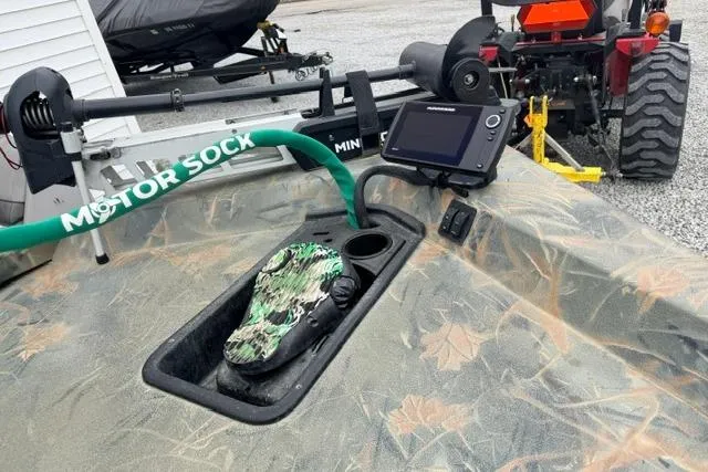 Slide: The Image of 2017 Ranger RT188 boat with trolling motor, camo pattern, and electronic display. - 7