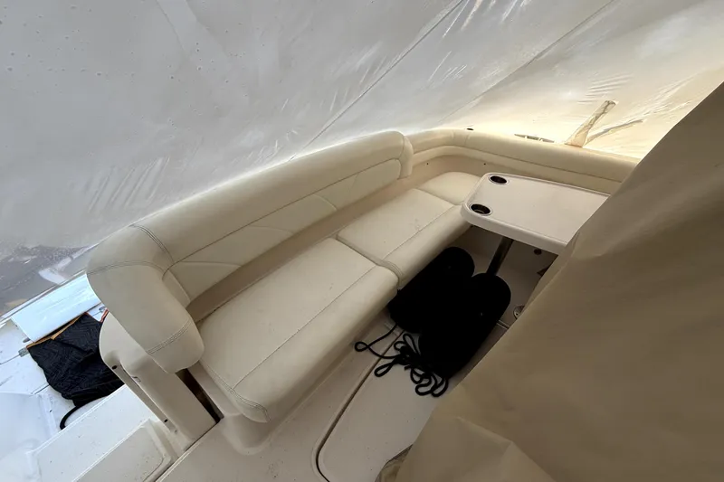 Slide: The Image of Interior seating area of 2006 Tiara Yachts 4300 Sovran with table and cushions. - 1
