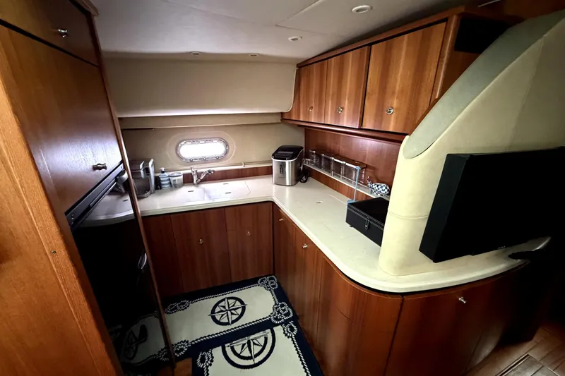 Slide: The Image of Luxurious 2006 Tiara Yachts 4300 Sovran galley with wood cabinetry and modern amenities. - 10