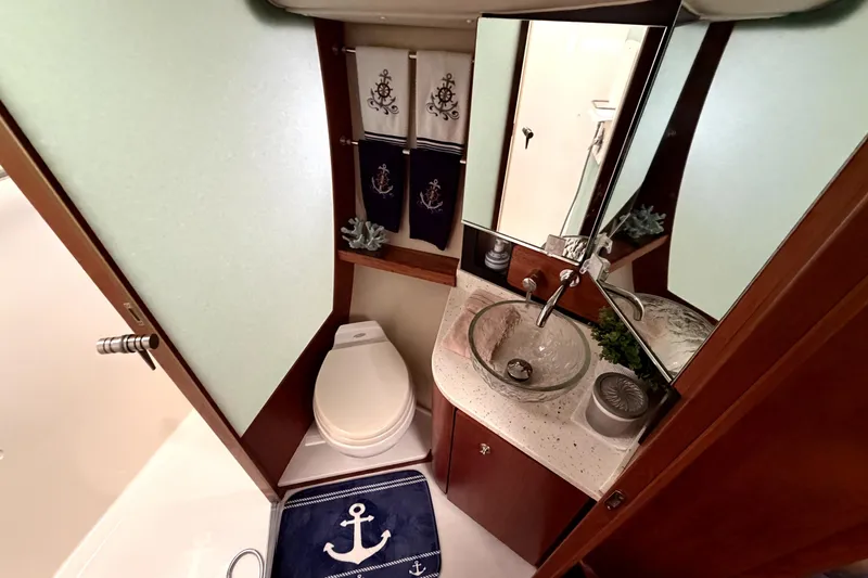 Slide: The Image of Luxurious 2006 Tiara Yachts 4300 Sovran bathroom with nautical decor and modern amenities. - 14