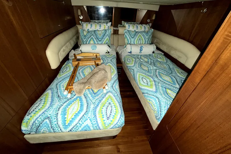 Slide: The Image of Luxurious 2006 Tiara Yachts 4300 Sovran cabin with twin beds and vibrant bedding. - 15