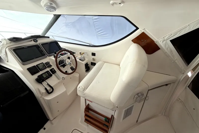 Slide: The Image of 2006 Tiara Yachts 4300 Sovran helm with modern navigation equipment and comfortable seating. - 3