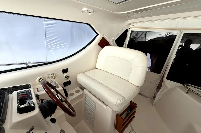 Slide: The Image of 2006 Tiara Yachts 4300 Sovran helm with white captain's chair and steering wheel. - 7