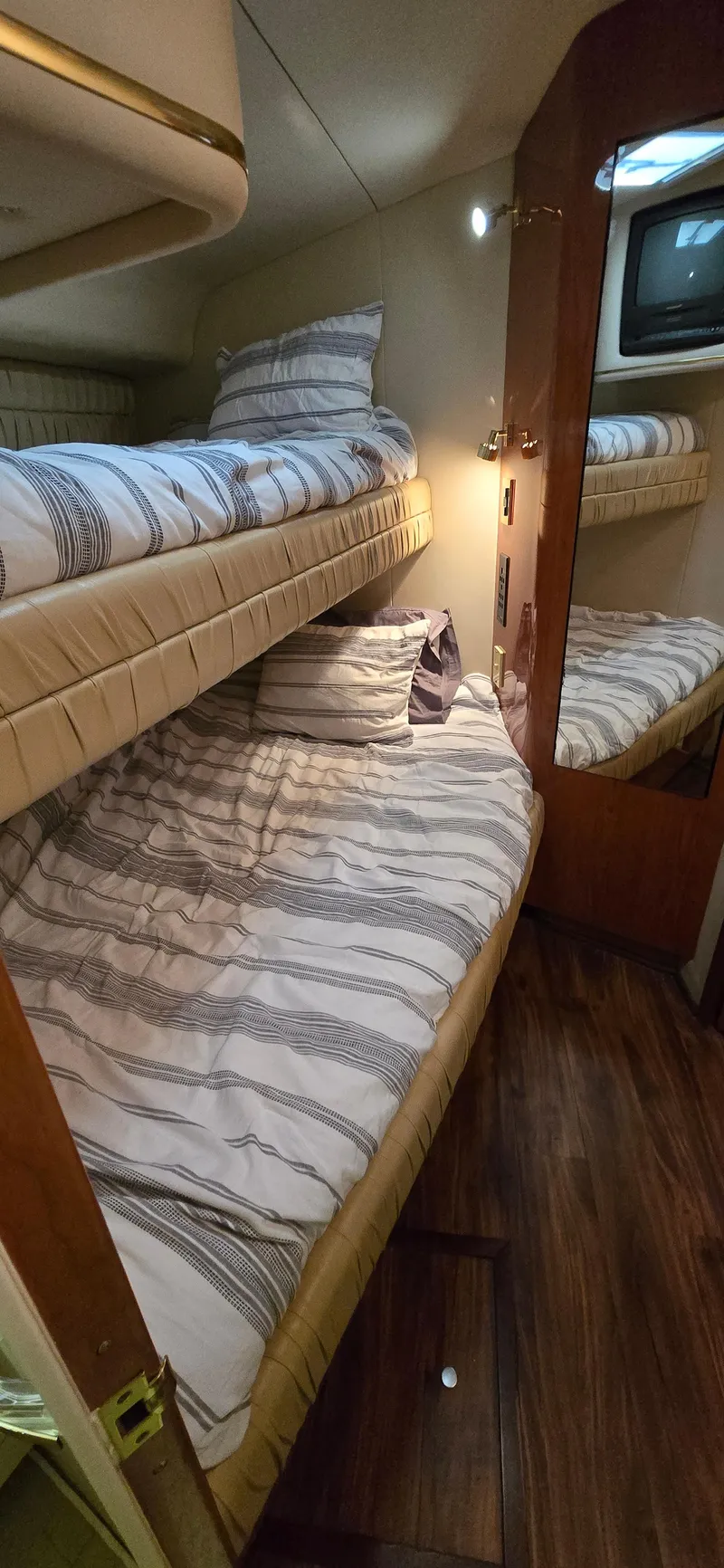 Slide: The Image of 1999 Sea Ray 50 Sundancer cabin with bunk beds and wood flooring. - 20