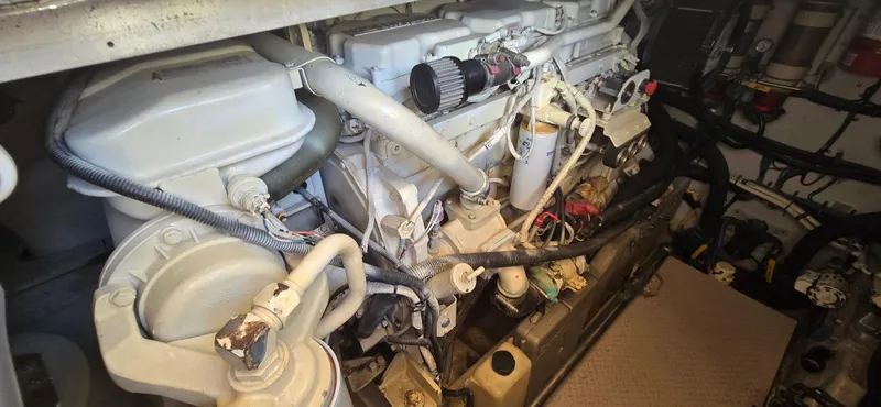 Slide: The Image of Engine room of 1999 Sea Ray 50 Sundancer yacht, showcasing mechanical components. - 25