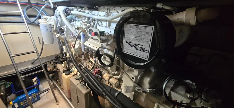 Slide: The Image of Engine room of 1999 Sea Ray 50 Sundancer yacht, showcasing mechanical components and equipment. - 27