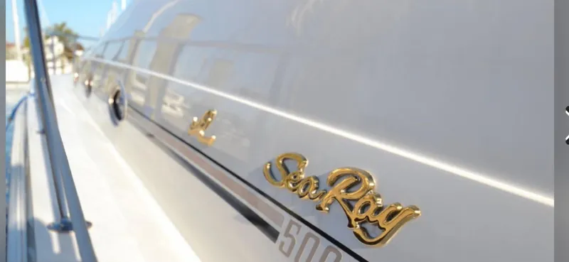 Slide: The Image of Close-up of 1999 Sea Ray 50 Sundancer yacht with gold logo. - 6