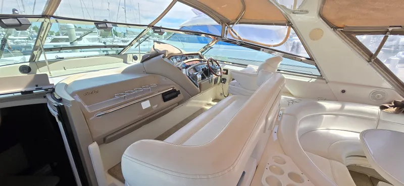 Slide: The Image of Interior of 1999 Sea Ray 50 Sundancer yacht with luxurious seating and helm. - 7