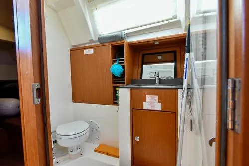 Slide: The Image of 2016 Bavaria Cruiser 41 bathroom with wooden cabinetry and modern fixtures. - 18