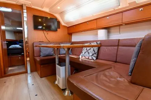 Slide: The Image of 2016 Bavaria Cruiser 41 interior with cozy seating, wooden finishes, and mounted TV. - 19