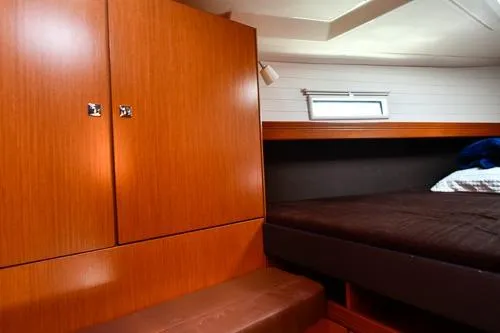 Slide: The Image of Interior cabin of 2016 Bavaria Cruiser 41 yacht with wooden cabinetry and cozy bed. - 23