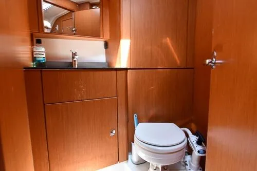 Slide: The Image of 2016 Bavaria Cruiser 41 yacht bathroom with wooden cabinetry and modern fixtures. - 27