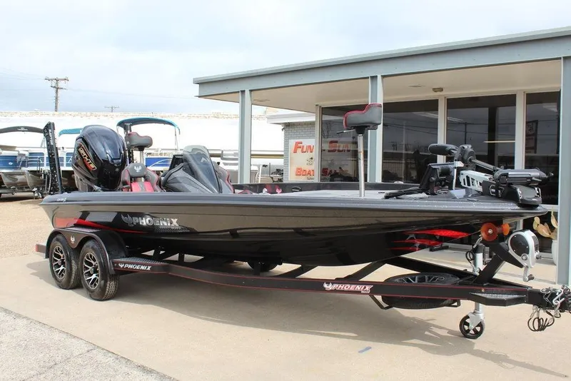 The Image of 2026 Phoenix 920 Elite X boat on trailer, parked outside a dealership. - 1