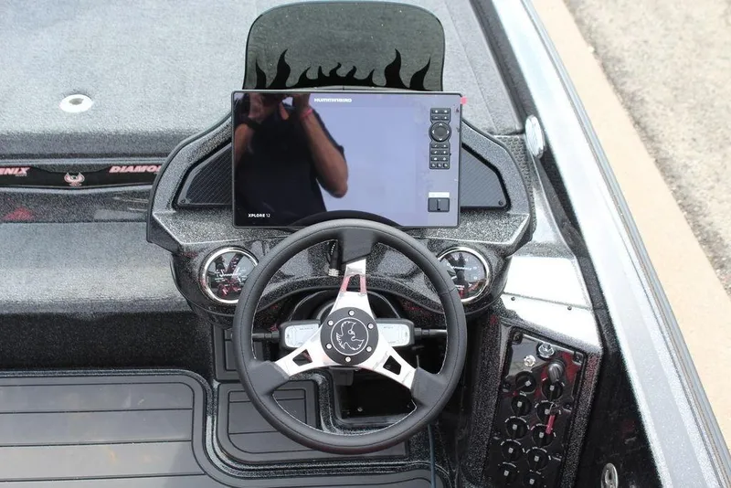 Slide: The Image of Dashboard of a 2026 Phoenix 920 Elite X boat with steering wheel and display. - 17