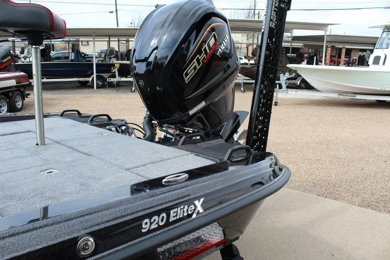 Slide: The Image of 2026 Phoenix 920 Elite X boat with powerful outboard motor in a showroom. - 19