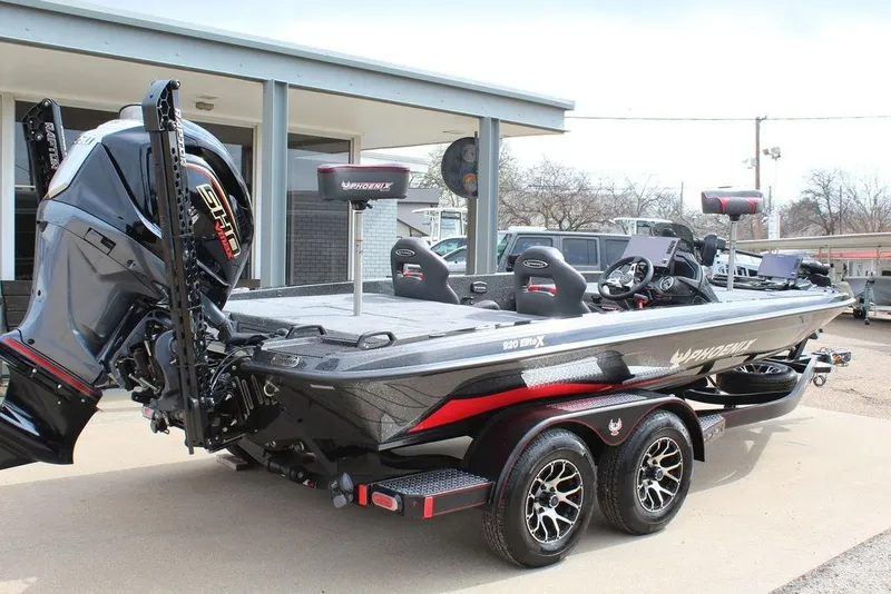 Slide: The Image of 2026 Phoenix 920 Elite X fishing boat with dual console and powerful outboard motor. - 2