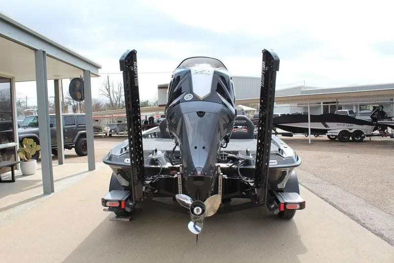 Slide: The Image of 2026 Phoenix 920 Elite X boat with powerful outboard motor, parked at dealership. - 3