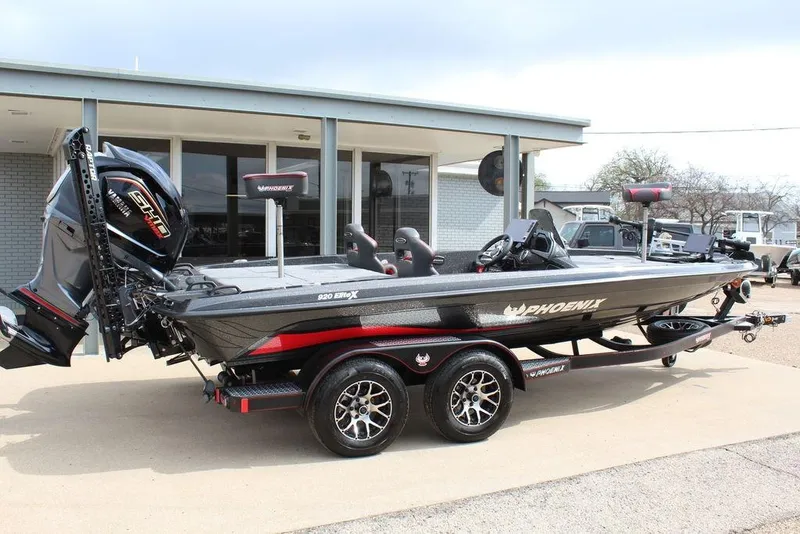 Slide: The Image of 2026 Phoenix 920 Elite X boat with trailer, parked outside a building. - 4